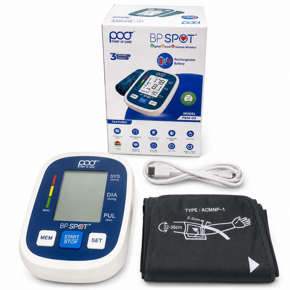 A digital upper arm blood pressure monitor set shown on a white background, including the monitor unit, arm cuff, charging cable, and product box. The monitor is white and blue, and the cuff is black.